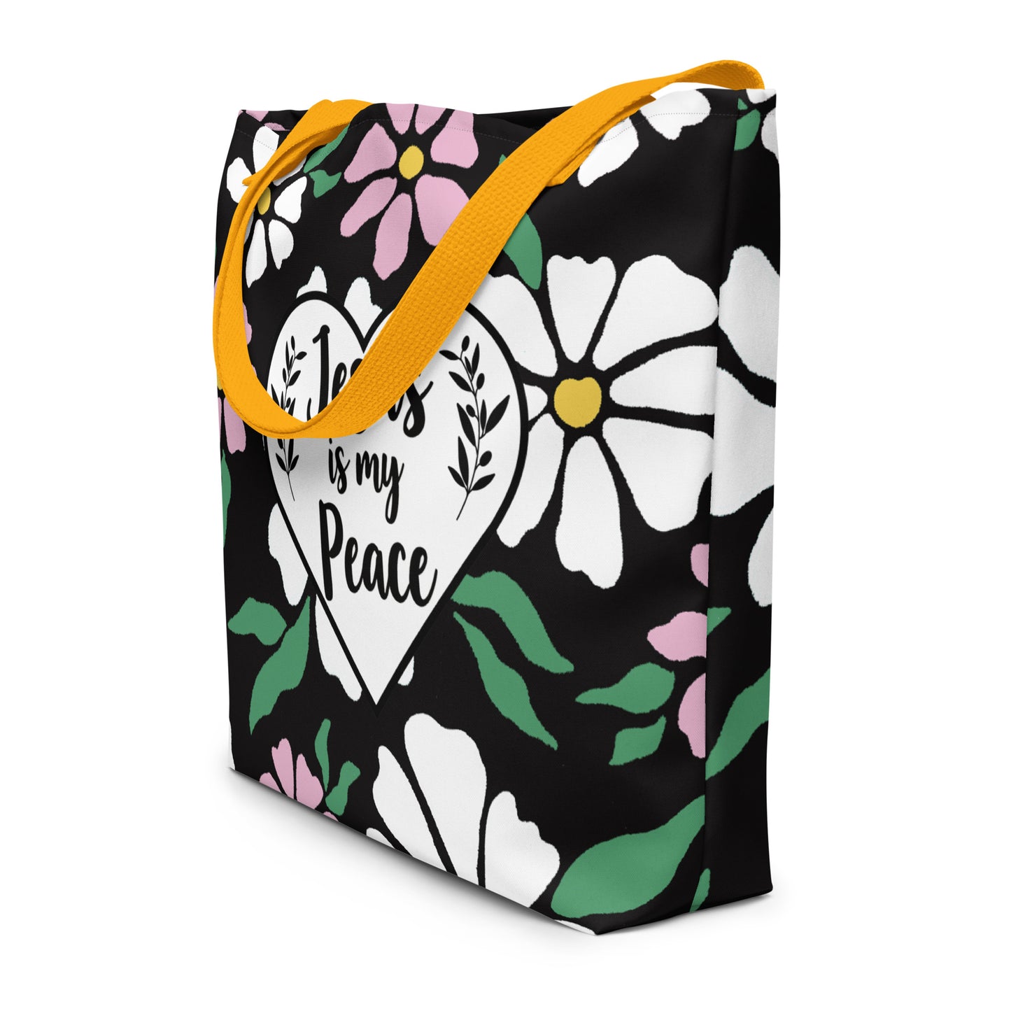 Angled view of black floral tote bag with yellow straps and “Jesus is my Peace” heart graphic.