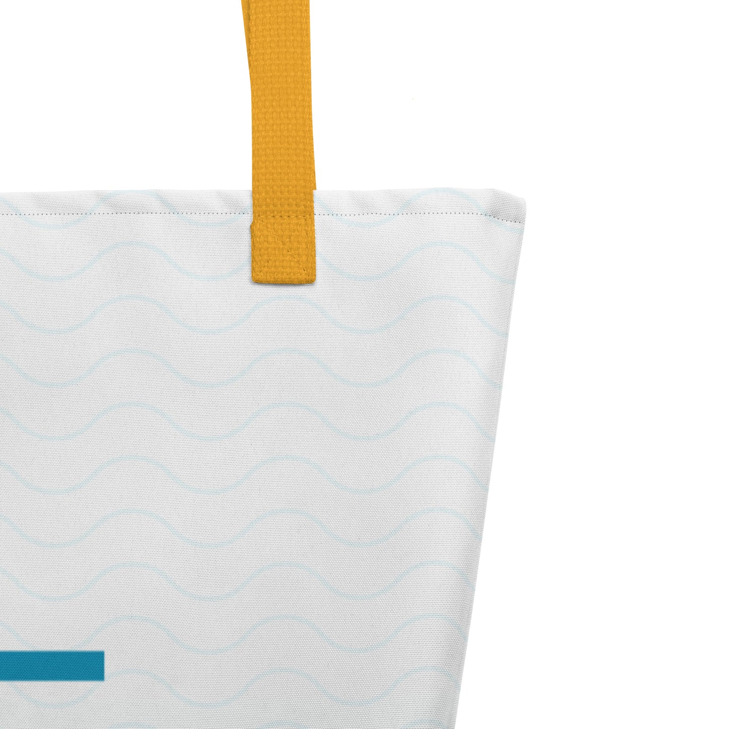 Close-up of mustard yellow woven handle and stitched top edge on the tote bag’s white fabric with subtle wave pattern.