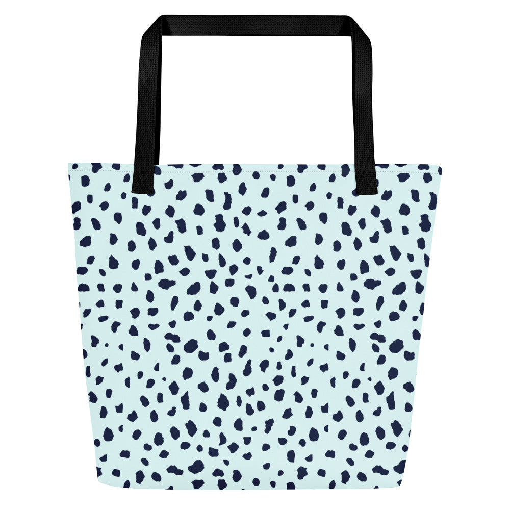 Back view of light blue tote bag with black straps and the same navy speckled pattern, without the front graphic.