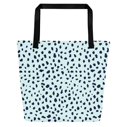 Back view of light blue tote bag with black straps and the same navy speckled pattern, without the front graphic.