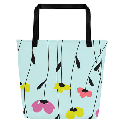 Back view of the tote showing the same pale aqua/mint background with an all-over scattered flower-and-stem pattern in pink, coral-red, and yellow, with black stems; black straps at the top.