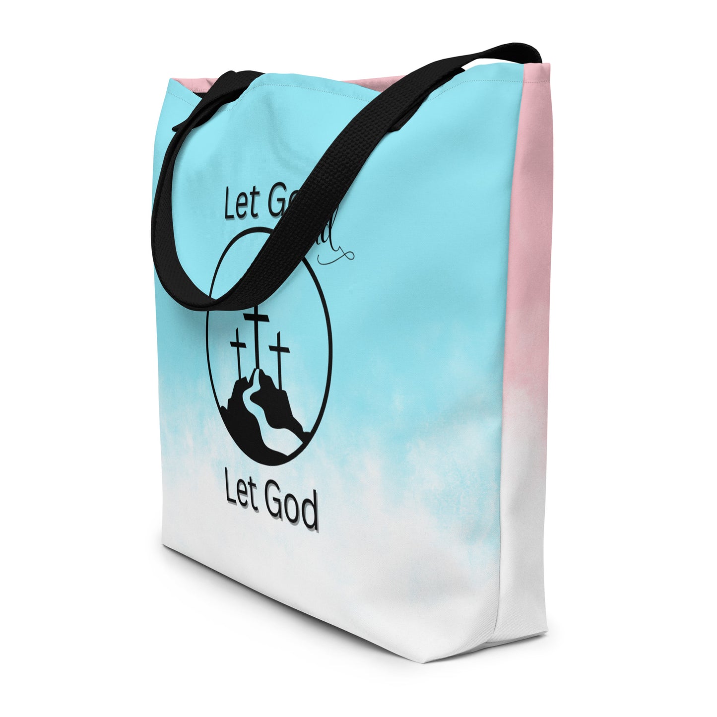 Angled view of ombré tote bag with black straps and “Let Go and Let God” graphic with three crosses.