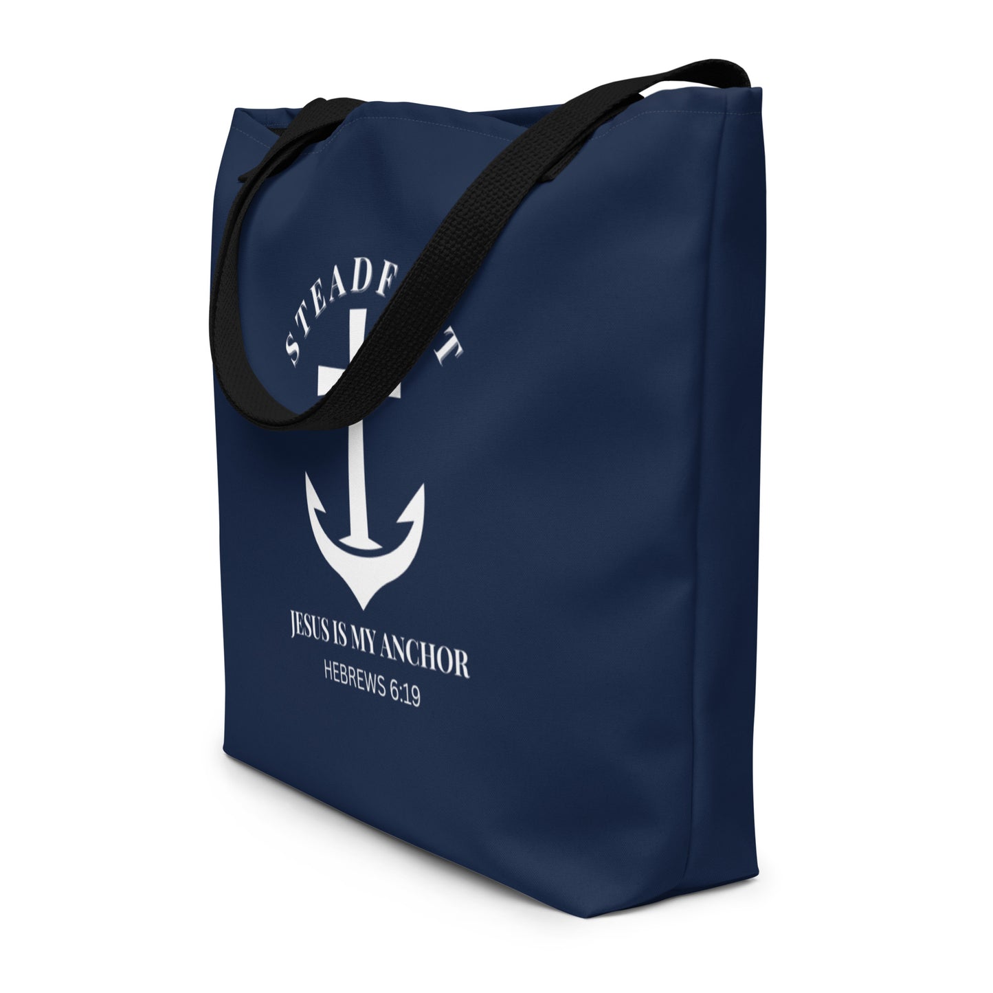 Angled view of navy tote bag with black straps and white “Steadfast” anchor-and-cross graphic with Hebrews 6:19.