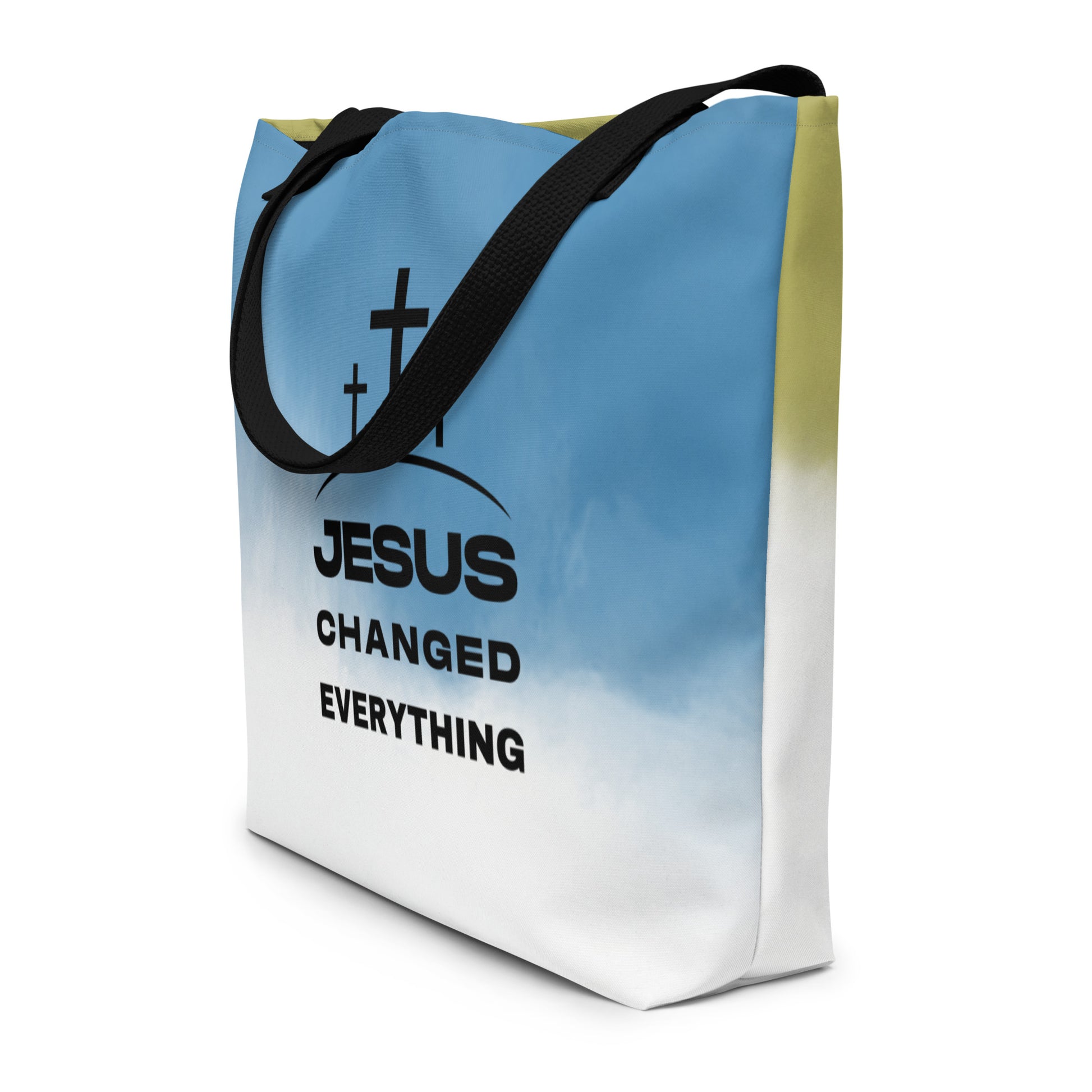 Angled view of ombré tote bag with black straps and “JESUS CHANGED EVERYTHING” text with three crosses.