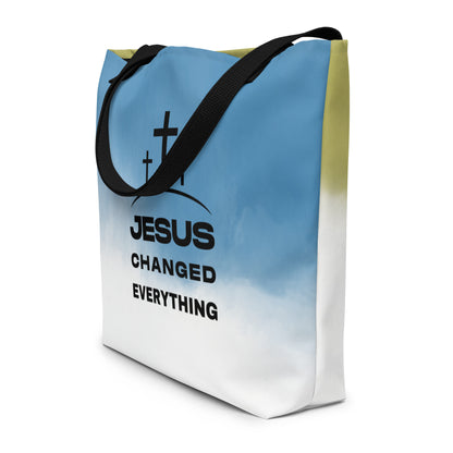 Angled view of ombré tote bag with black straps and “JESUS CHANGED EVERYTHING” text with three crosses.