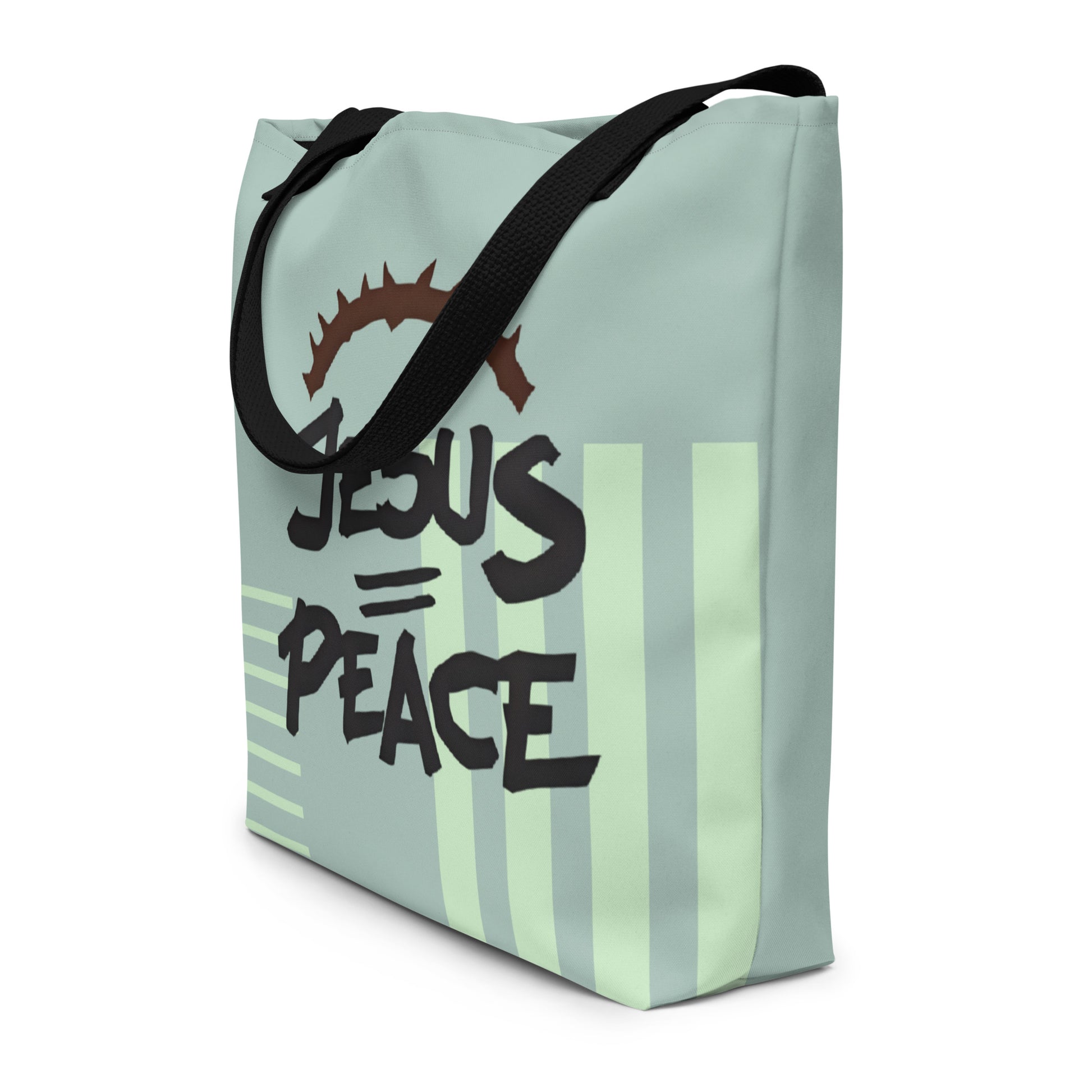 Angled view of sage green tote bag with black straps, pale stripe accents, and “JESUS = PEACE” text with crown of thorns.