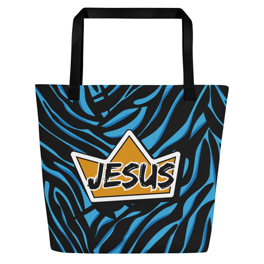 Front view of a large tote bag with black webbing straps and a bold black-and-blue zebra-style pattern. A yellow crown-shaped graphic is centered on the bag with the word “JESUS” in a black brush-style font outlined in white.