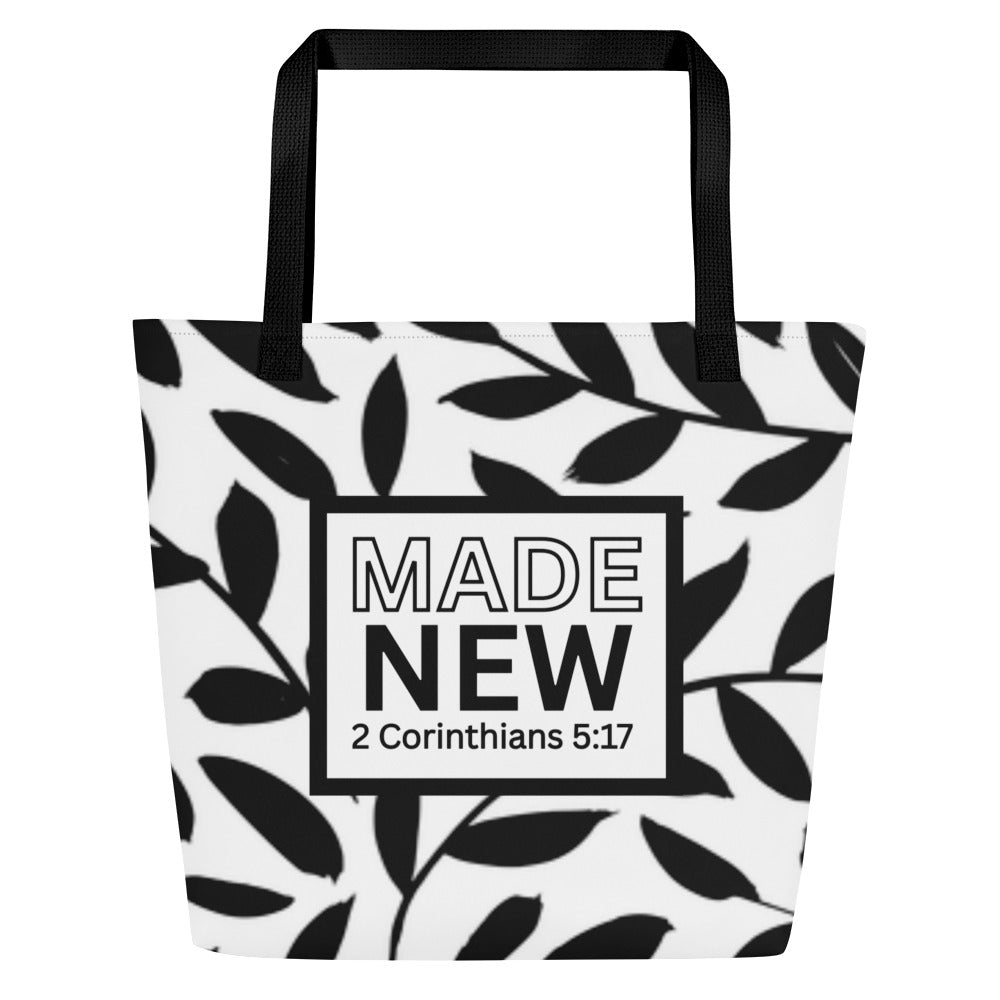 Front view of black-and-white tote bag with black straps, leafy pattern, and boxed text reading “MADE NEW” with “2 Corinthians 5:17.”