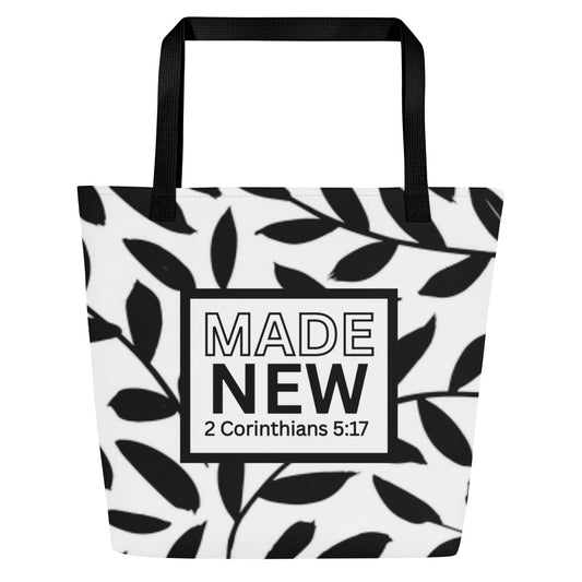 Front view of black-and-white tote bag with black straps, leafy pattern, and boxed text reading “MADE NEW” with “2 Corinthians 5:17.”