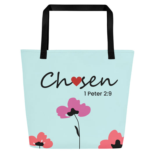 Front view of a large tote bag with black webbing straps and a pale aqua/mint background. The word “Chosen” appears in black script with a red heart used as the “o,” and “1 Peter 2:9” printed beneath in smaller black text. Simple floral illustrations decorate the bottom corners, including pink and coral-red flowers and a taller pink flower with a thin black stem in the center.