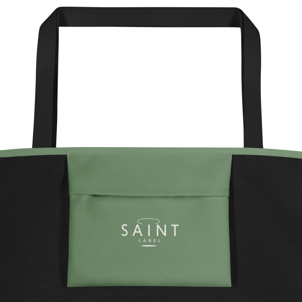 Inside pocket view showing a sage green interior pocket labeled “Saint Label,” with black side panels.