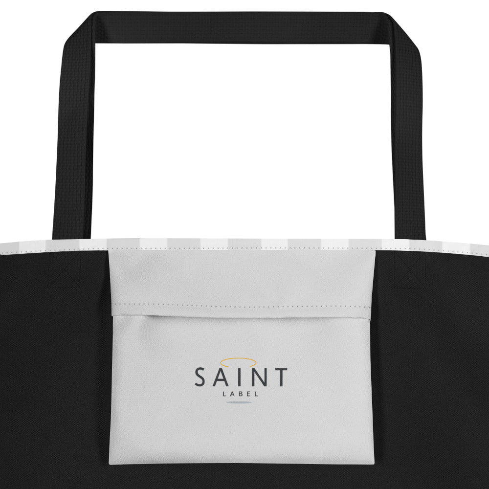 Inside pocket view showing black side panels and a light gray pocket panel with “Saint Label” printed in small, dark lettering; black straps visible at the top.