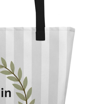 Close-up of the front design showing the olive-green laurel wreath, small cross, and the text “resting in HIS promises” with “Matt 11:28–30” beneath it on the pale striped background.