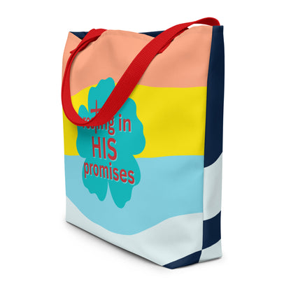 Angled view of the tote showing red straps and the wraparound design—color-block front with teal flower “resting in HIS promises” graphic and navy-and-white wave pattern continuing around the sides/back.