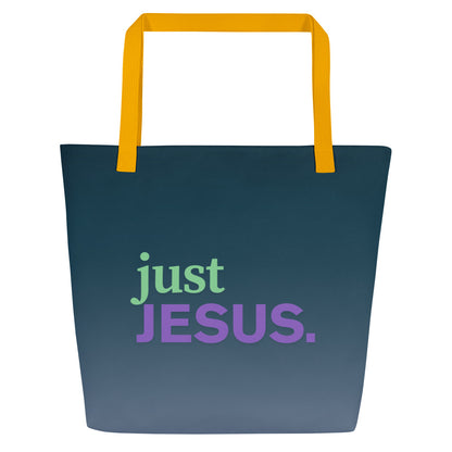 Front view of dark teal tote bag with yellow straps and the phrase “just JESUS.” in green and purple lettering.