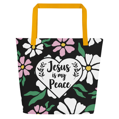 Front view of black tote bag with yellow straps, bold floral print, and a white heart graphic reading “Jesus is my Peace.”