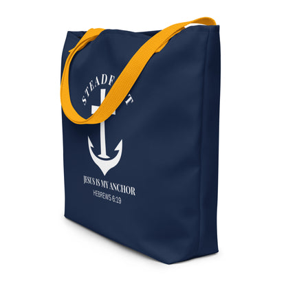 Angled view of navy tote bag with yellow straps and white “Steadfast” anchor-and-cross graphic with Hebrews 6:19.