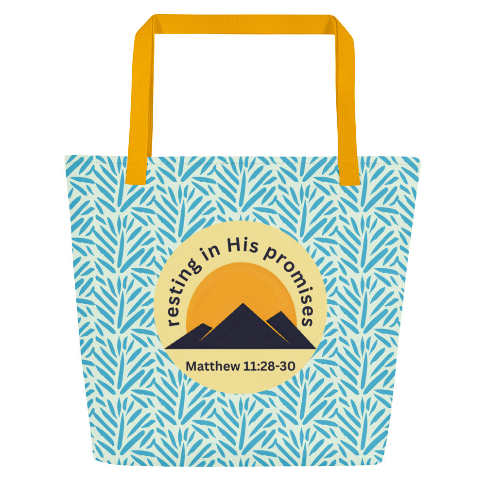 Front view of light blue patterned tote bag with mustard yellow straps and a circle mountain graphic reading “resting in His promises” and “Matthew 11:28–30.”