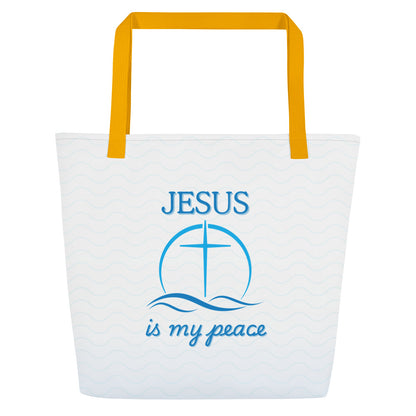 Front view of a large tote bag with golden-yellow straps and a white body patterned with faint light-blue waves. Centered blue artwork shows the word “JESUS” above a cross inside a circle, with wave lines below and the phrase “is my peace” in blue script.