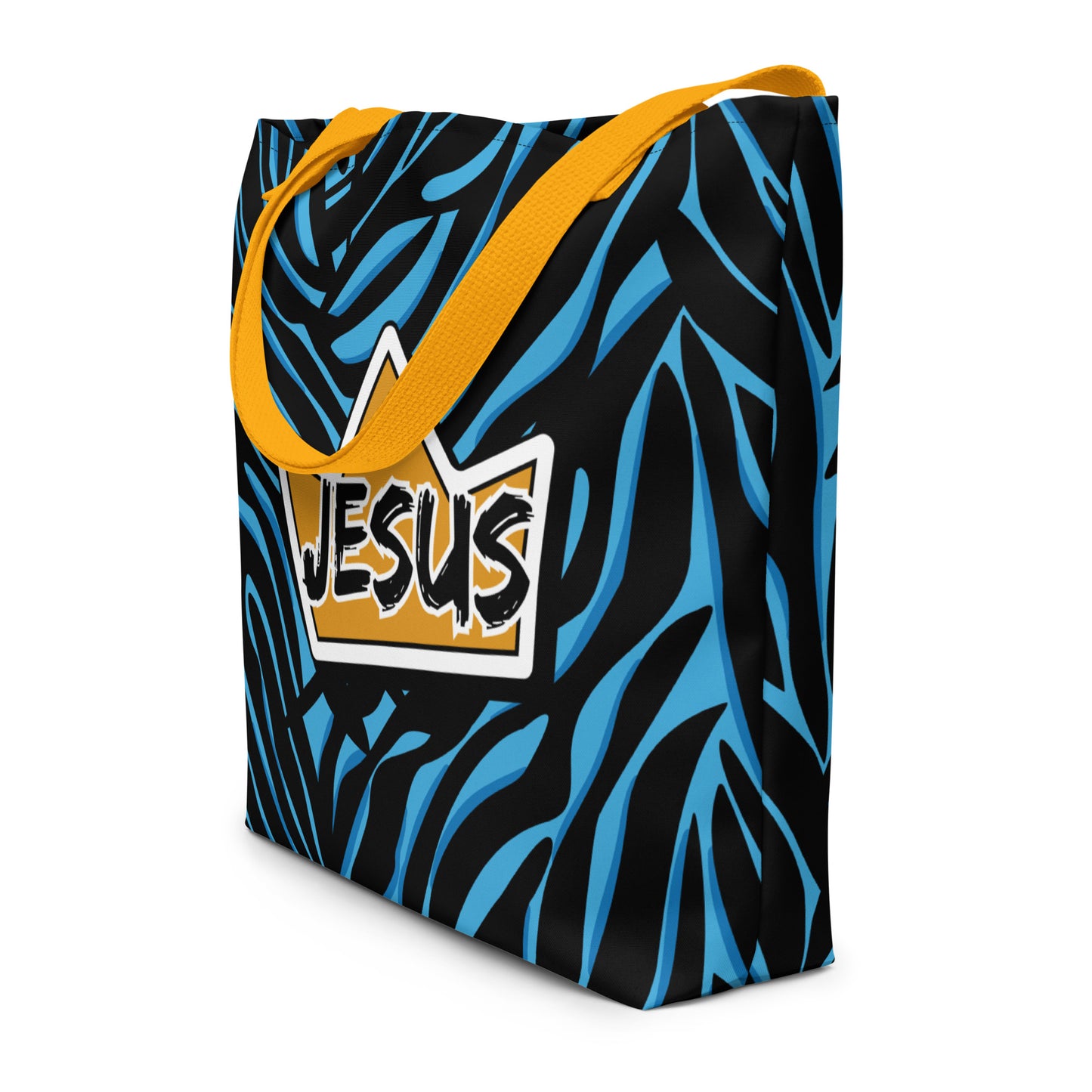 Angled view of the tote showing the black-and-blue zebra-style pattern wrapping around the sides and the centered yellow crown “JESUS” graphic on the front; yellow straps hang over the top edge.