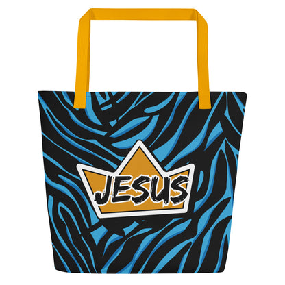 Front view of a large tote bag with yellow webbing straps and a bold black-and-blue zebra-style pattern. A yellow crown-shaped graphic is centered on the bag with the word “JESUS” in a black brush-style font outlined in white.