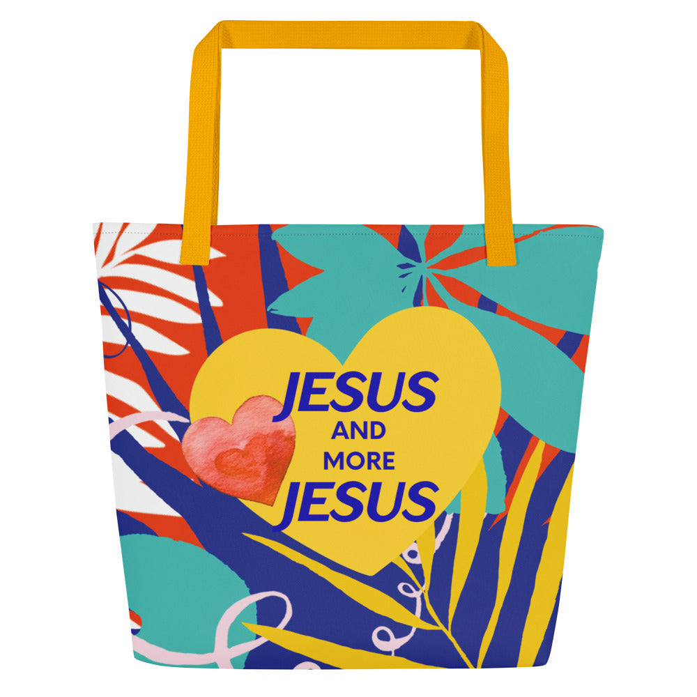 Front view of a large tote bag with mustard-yellow webbing straps and a bold, tropical abstract print. A large yellow heart is centered with blue text that reads “JESUS AND MORE JESUS,” and a small red watercolor-style heart overlaps the left side of the yellow heart.