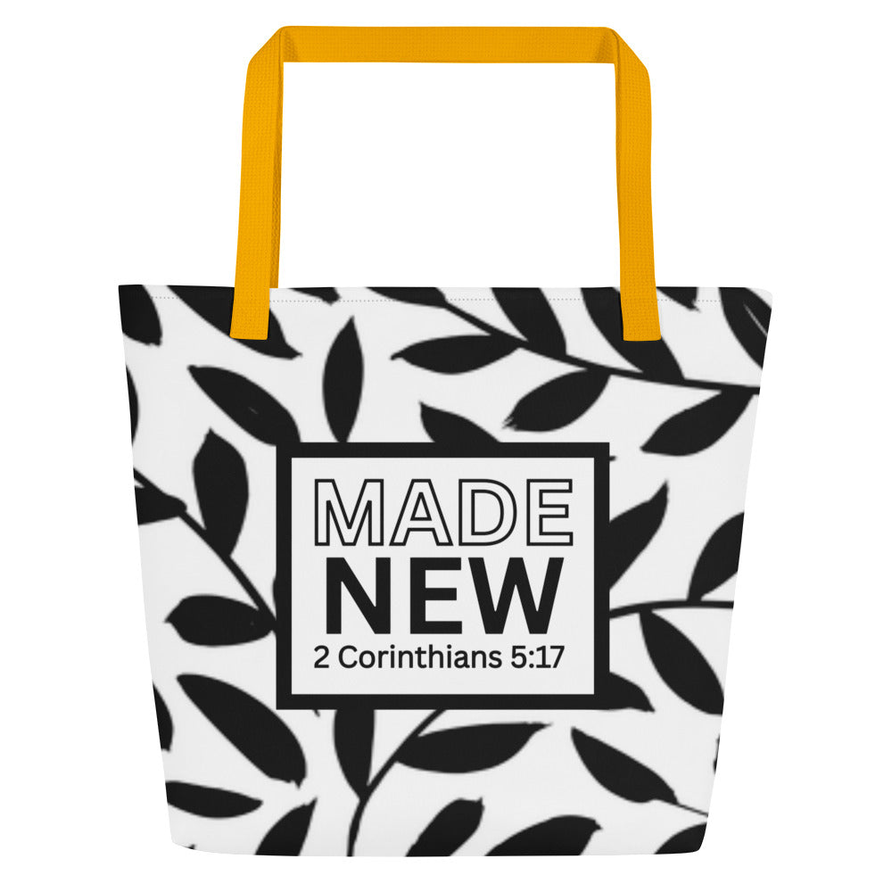 Front view of black-and-white tote bag with yellow straps, leafy pattern, and boxed text reading “MADE NEW” with “2 Corinthians 5:17.”
