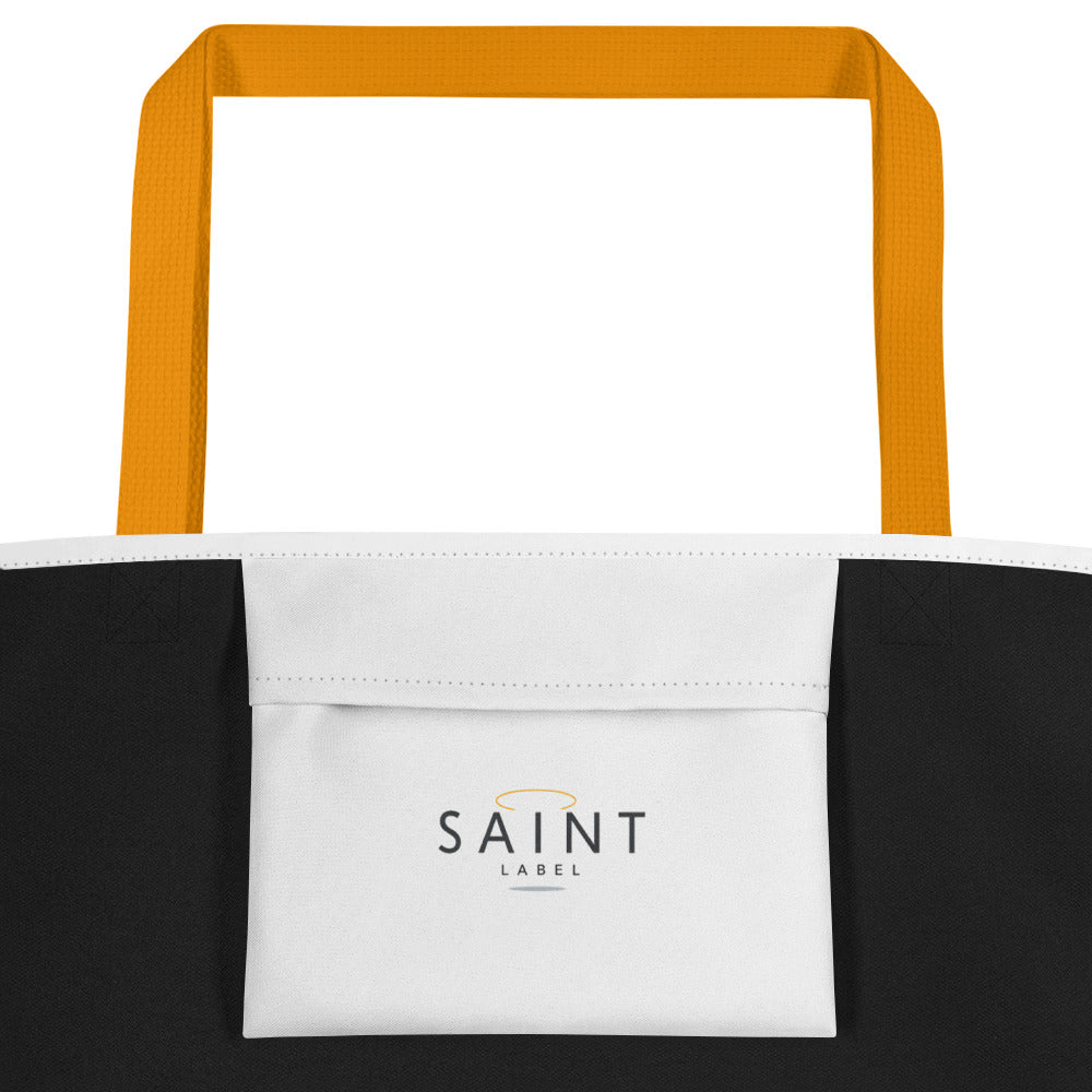 Interior view of the tote showing black side panels and a front interior pocket with a centered text “Saint Label." 