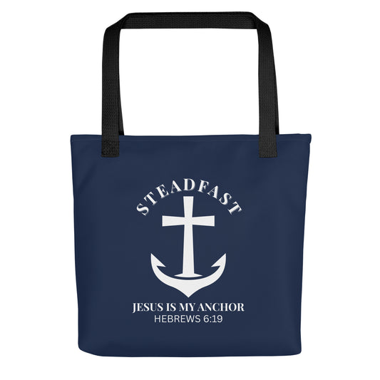 Front view of a navy blue Christian tote bag with black straps, featuring a white anchor-and-cross graphic and the text “STEADFAST” and “JESUS IS MY ANCHOR” with “HEBREWS 6:19” below.