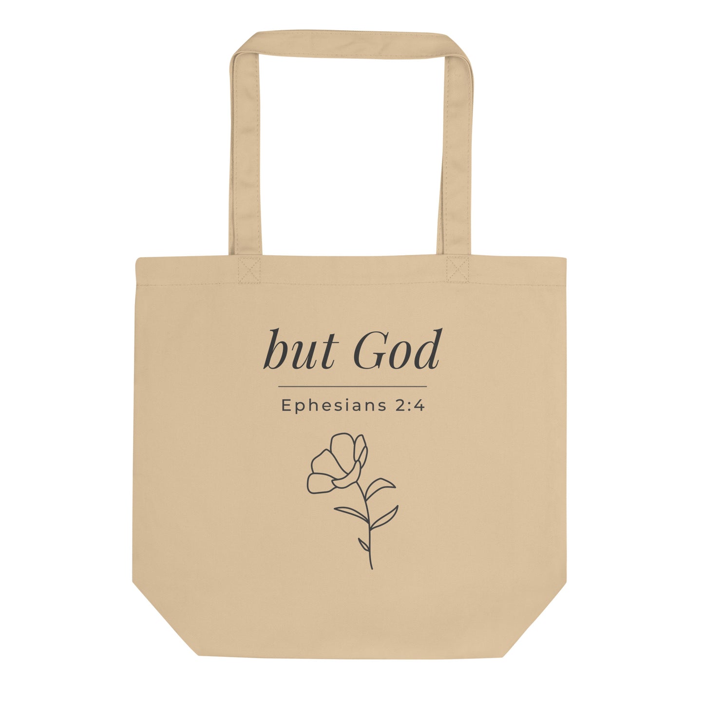 Front view of a natural cotton Christian tote bag with matching beige handles and “but God Ephesians 2:4” text.