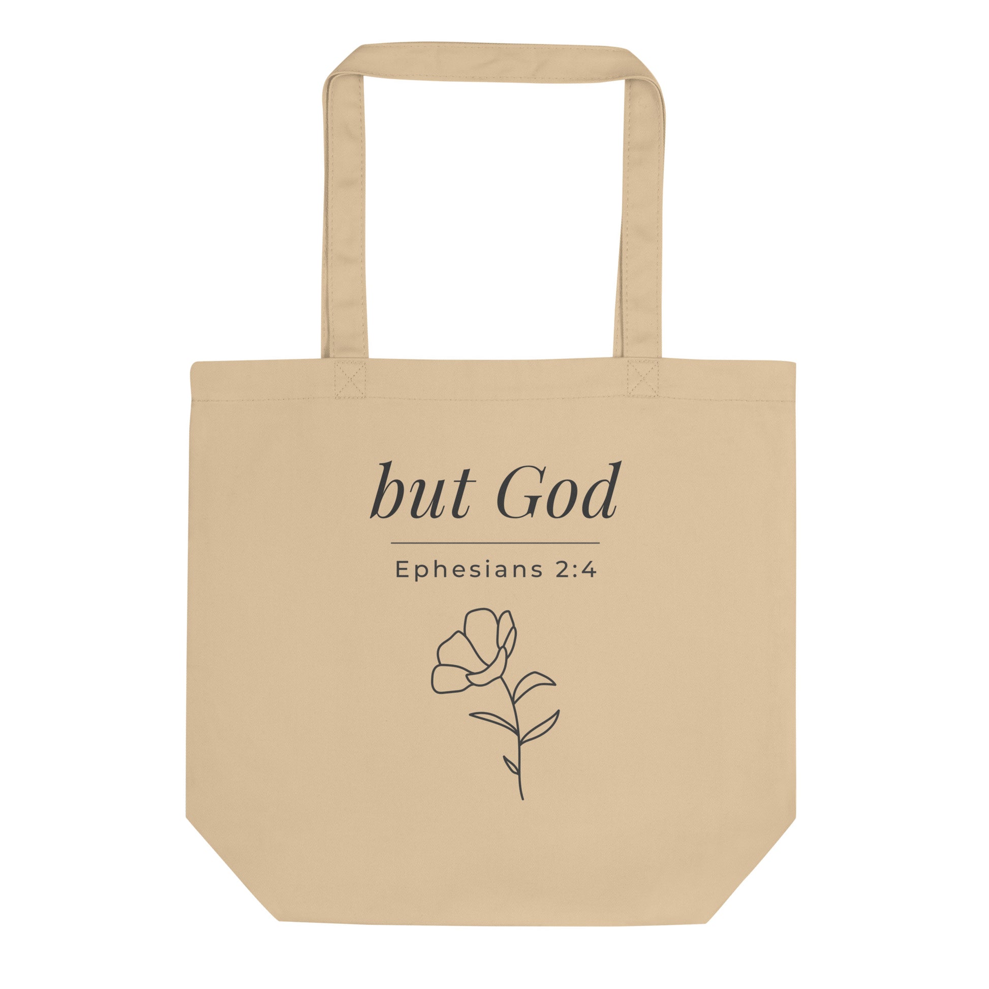Front view of a natural cotton Christian tote bag with matching beige handles and “but God Ephesians 2:4” text.
