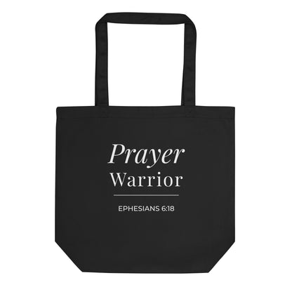 Front view of a black cotton Christian tote bag with white “Prayer Warrior” lettering, Ephesians 6:18, and a simple underline accent.