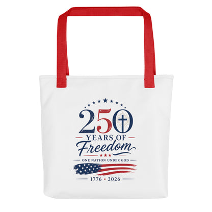 Front view of a white patriotic Christian tote bag with red handles and a “250 Years of Freedom” design.