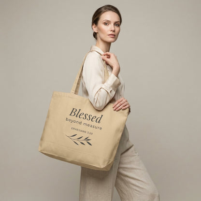 Model carrying a natural cotton Christian tote bag with beige handles and a “Blessed Beyond Measure Ephesians 3:20” design.