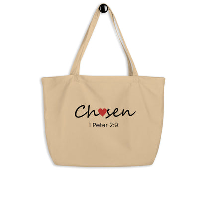 Large natural cotton tote bag hanging on a hook featuring “Chosen” with a red heart detail and “1 Peter 2:9” below.