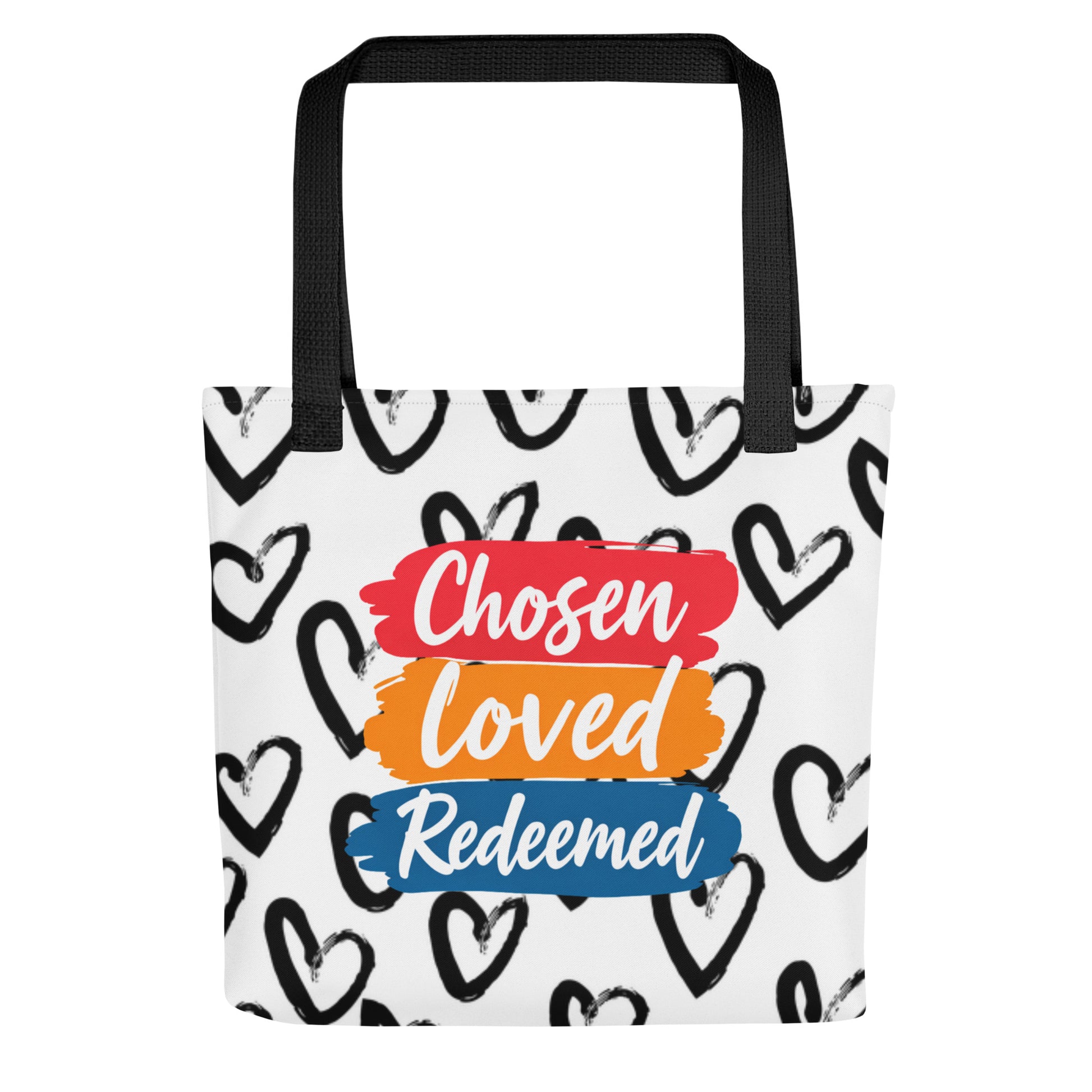 Front view of a white tote bag with black handles, black heart pattern, and stacked brushstroke text reading "Chosen," "Loved," and "Redeemed."