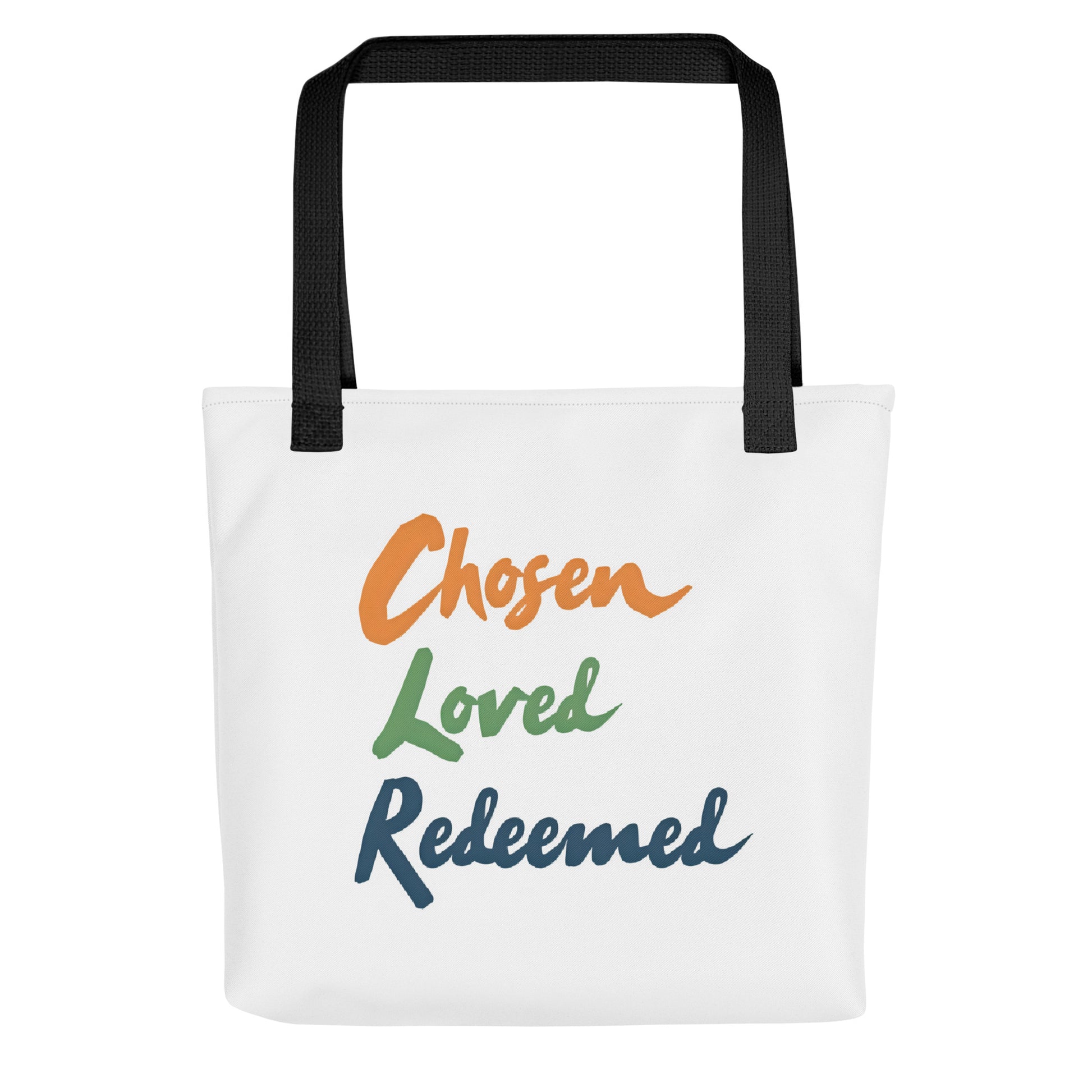 Front view of a white tote bag with black handles featuring the words “Chosen Loved Redeemed” in orange, green, and navy script.