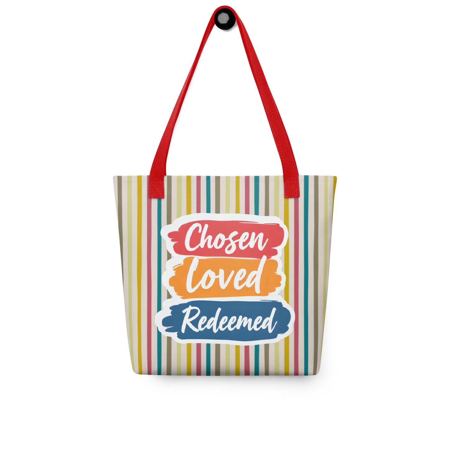Striped tote bag hanging on a hook with red handles and “Chosen Loved Redeemed” in white script on red, orange, and blue brushstroke shapes.