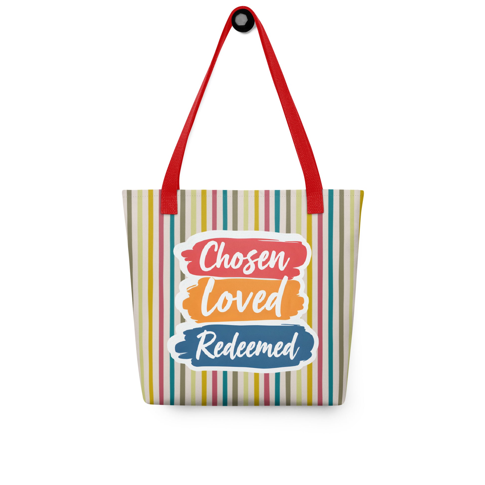Striped tote bag hanging on a hook with red handles and “Chosen Loved Redeemed” in white script on red, orange, and blue brushstroke shapes.
