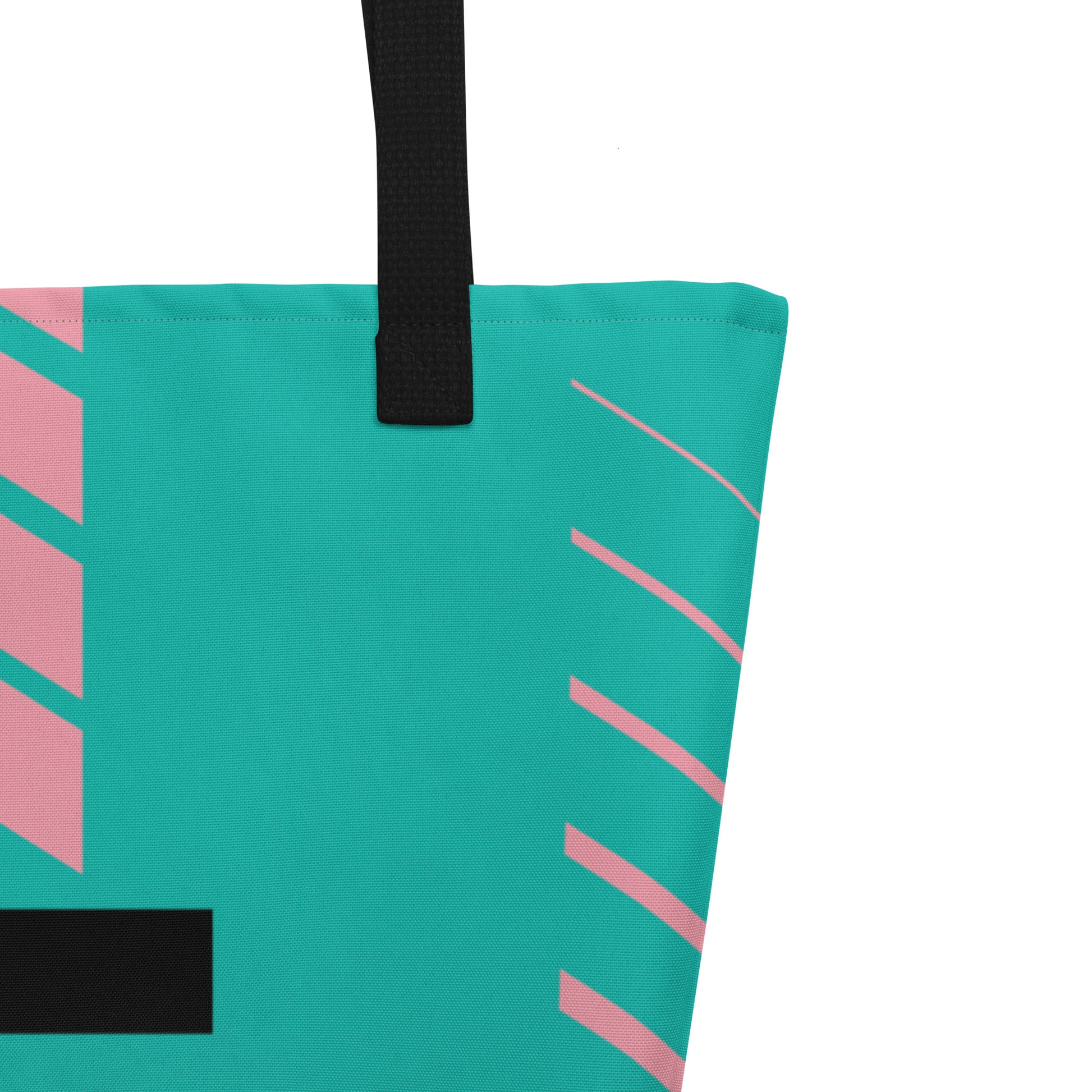 Close-up of black woven handle and stitched top edge on teal fabric with pink diagonal stripe accents.