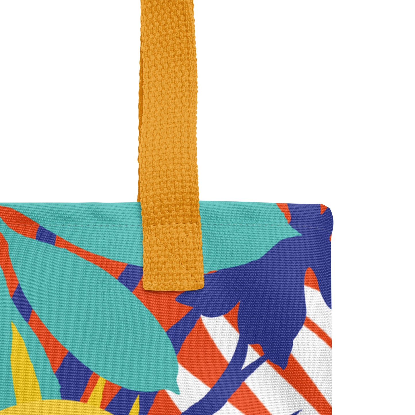 Close-up of the colorful floral tote fabric and mustard yellow strap, highlighting the stitching, textured canvas, and bold leaf pattern detail.