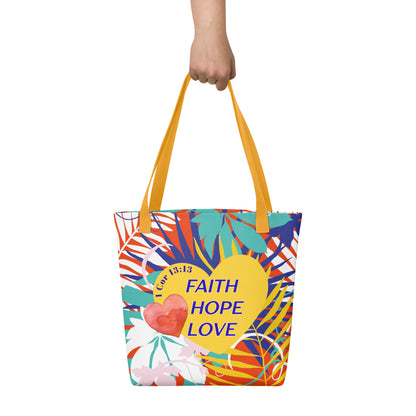 Colorful floral tote bag held in hand with mustard-yellow handles featuring “Faith Hope Love” and “1 Corinthians 13:13” on a yellow heart.