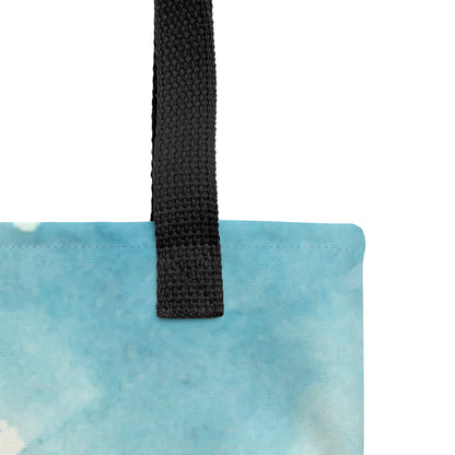 Close-up of the tote’s black woven strap and top seam on a light blue watercolor-printed fabric, showing the canvas texture and stitching.