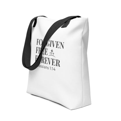 White Christian tote shown at an angle with stacked “Forgiven Free Forever” text and Colossians 1:14 beneath.