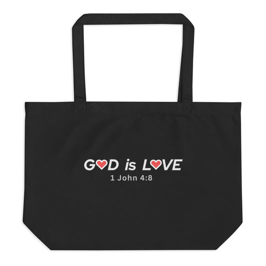 Large black cotton tote bag with “GOD is LOVE” in white text, red heart icons in the lettering, and “1 John 4:8” underneath.