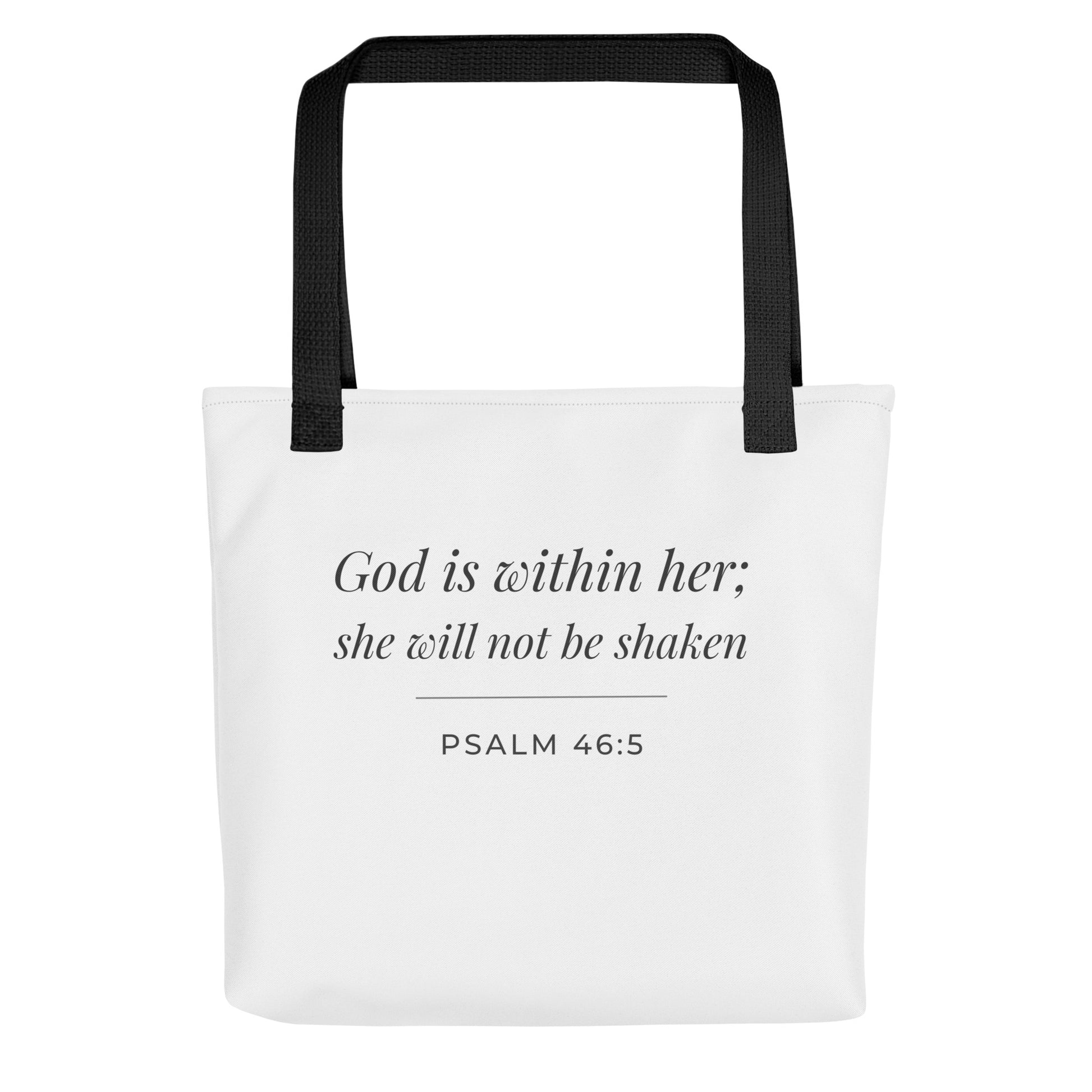 Front view of a white tote bag featuring ‘God is within her; she will not be shaken’ (Psalm 46:5) in dark gray.
