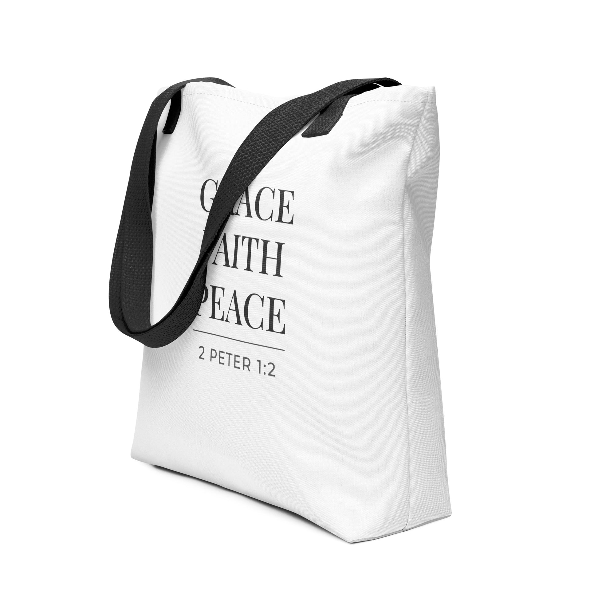 Angled view of a white Christian tote printed with “Grace Faith Peace” in dark gray and the scripture reference “2 Peter 1:2.”