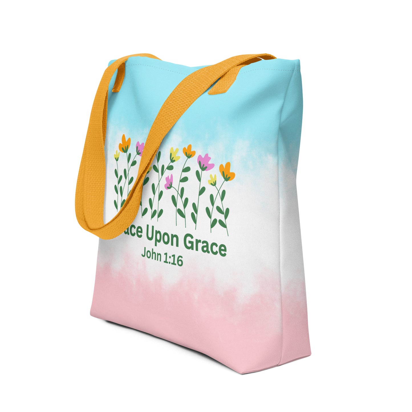 Angled view of a colorful Christian tote bag featuring yellow handles, soft pastel tie-dye colors, flowers, and “Grace Upon Grace John 1:16” text.
