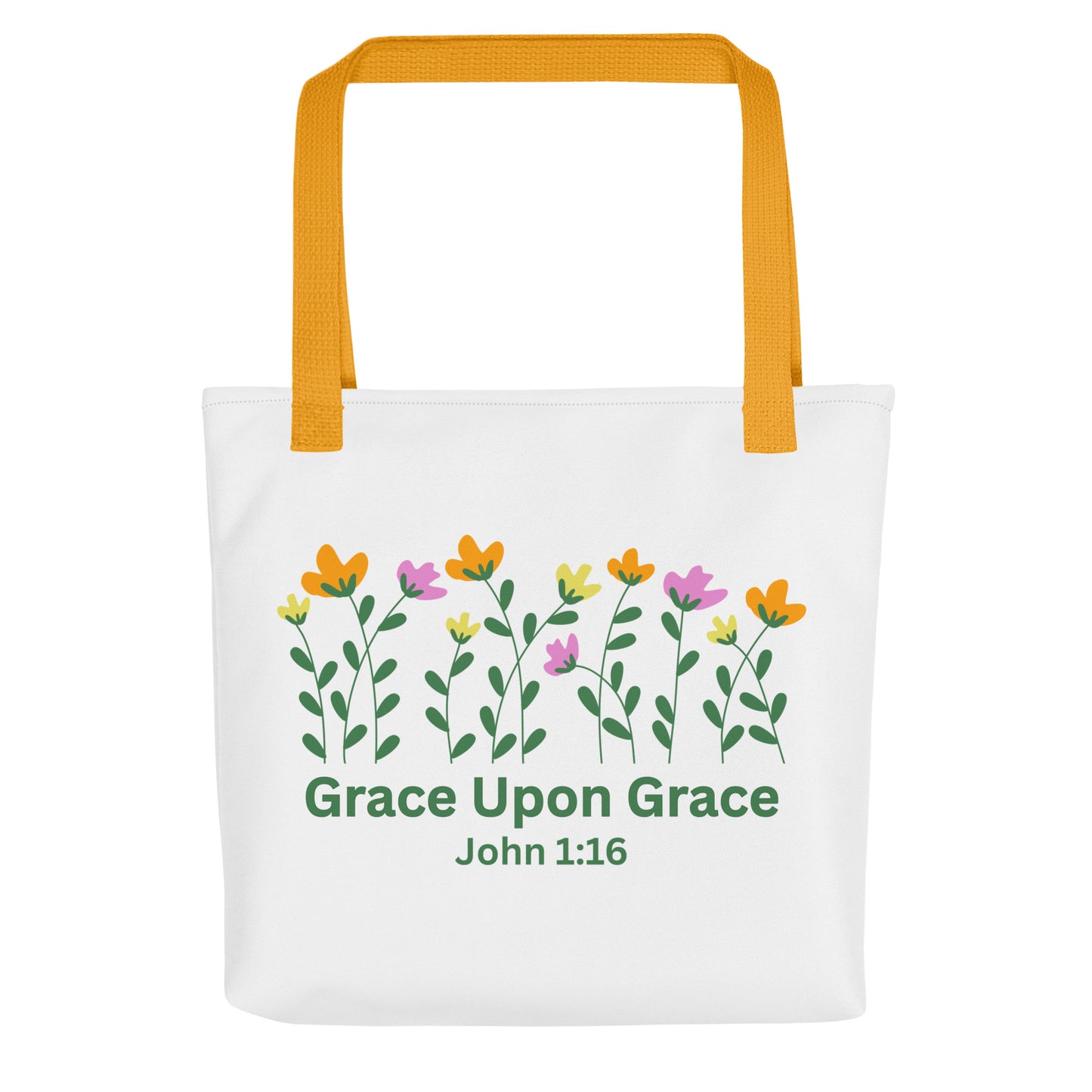Front view of a white ‘Grace Upon Grace’ John 1:16 tote bag with mustard-yellow straps and floral graphic above green text.