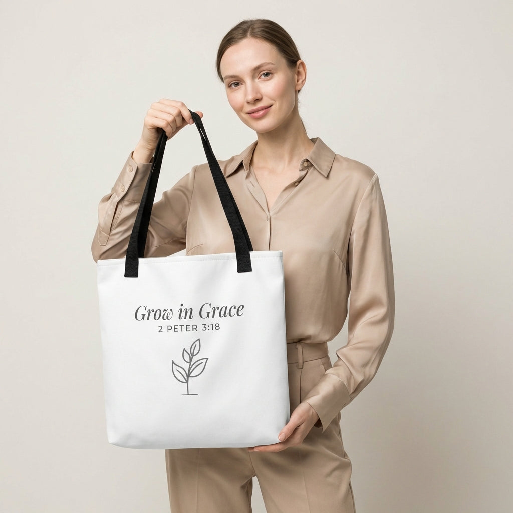 Lifestyle photo of a model holding a white tote bag with black handles featuring “Grow in Grace,” “2 Peter 3:18,” and a plant design in dark gray.